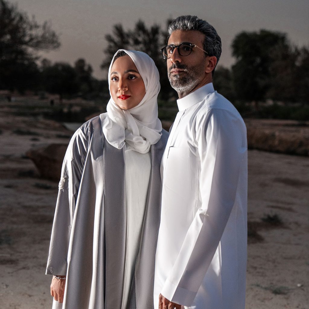Portrait of 05.10 Studio co-founders Ebtehal Ahmed AlRajhi and Mohammed AlSalahi, standing in front of a mixed media installation. The Riyadh-based duo blends fine art and architectural design to create immersive, identity-focused public art.