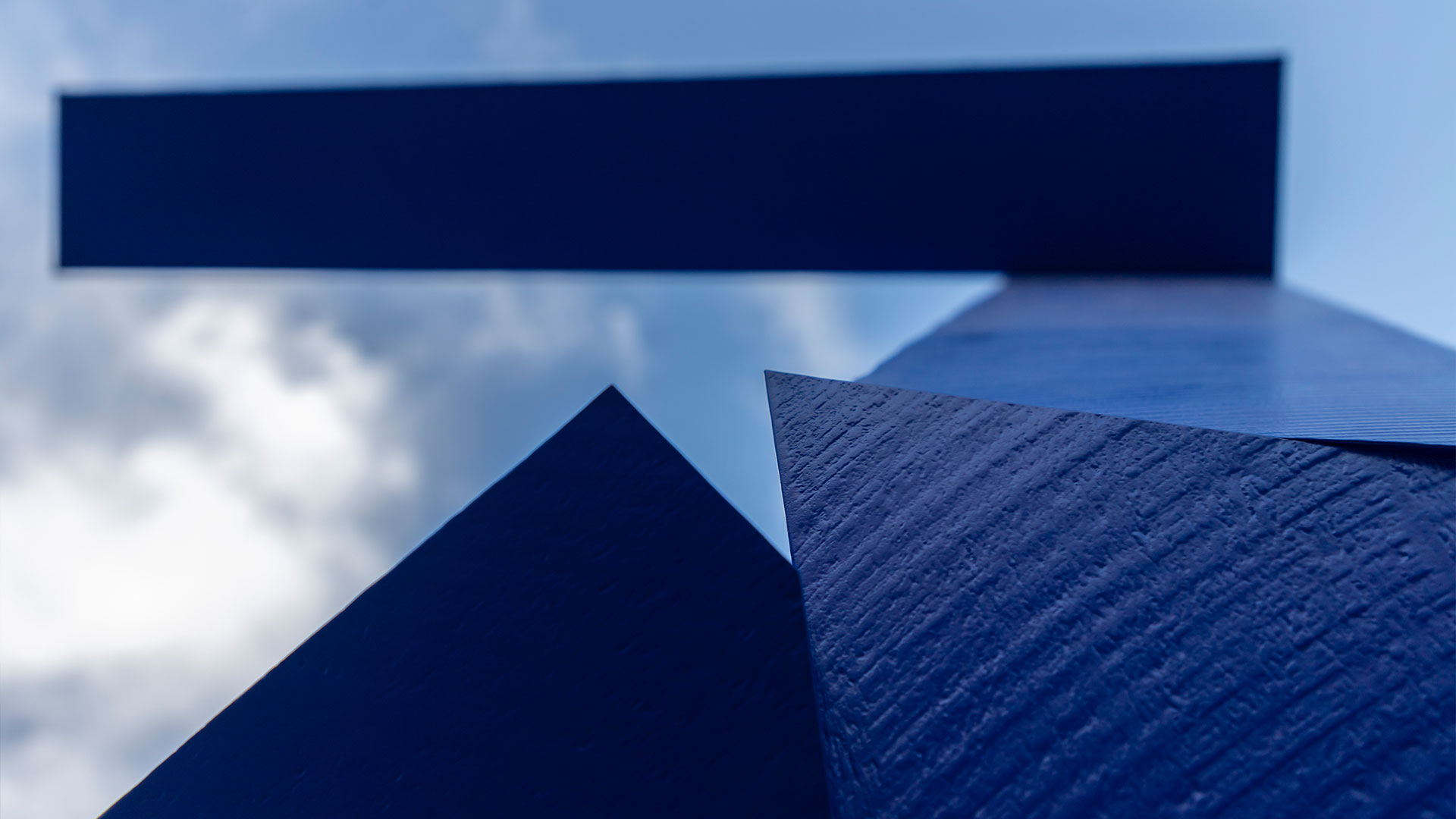 An abstract bronze sculpture by Joel Shapiro, titled Untitled, featuring angular forms that suggest a human figure in motion, installed outdoors in Riyadh.