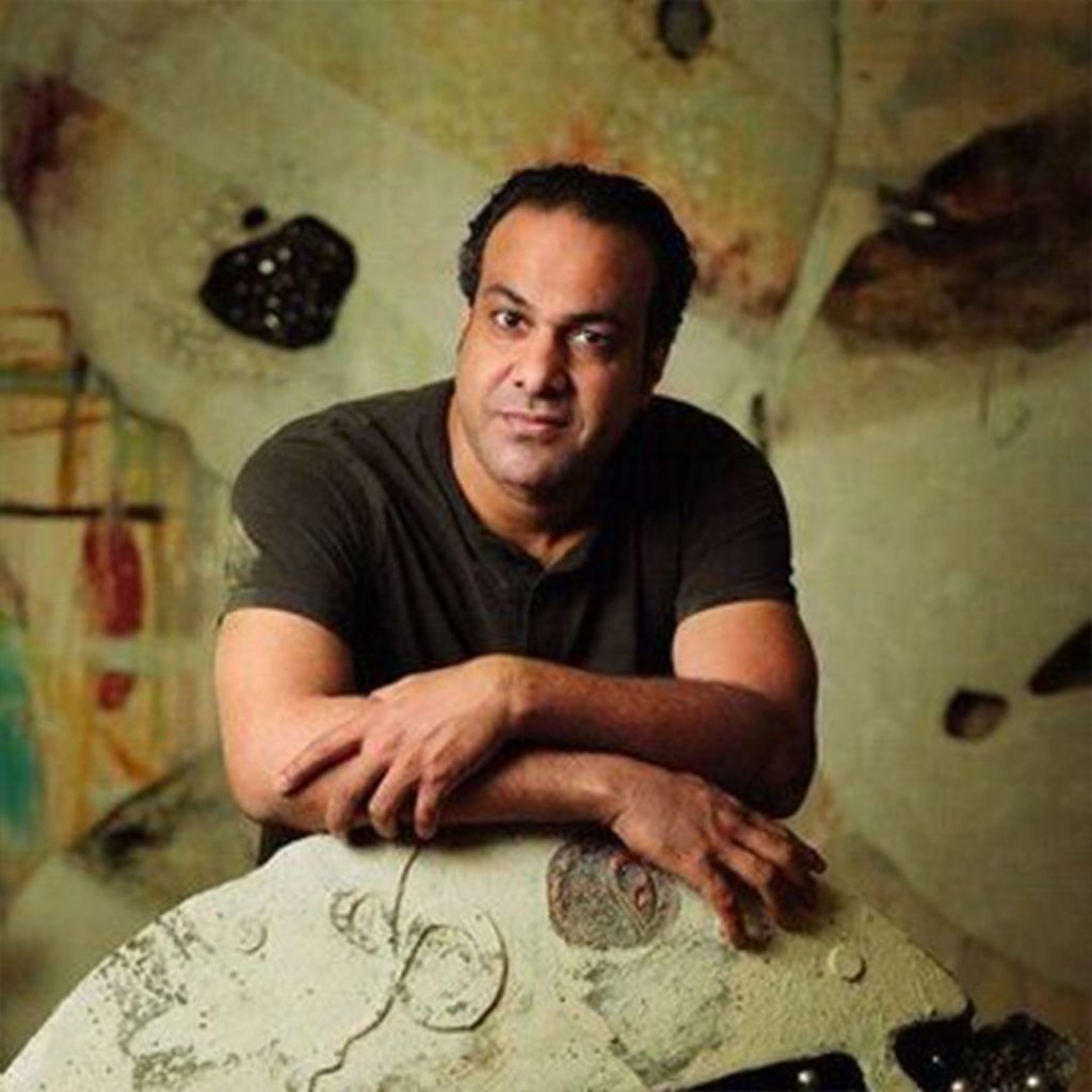 Portrait of Zaman Jassim (b. 1971), Saudi contemporary artist, known for spiritually resonant artworks that combine calligraphy, abstraction, and cultural symbolism.